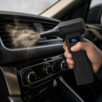 Cordless air blower clearing dust from a car air vent